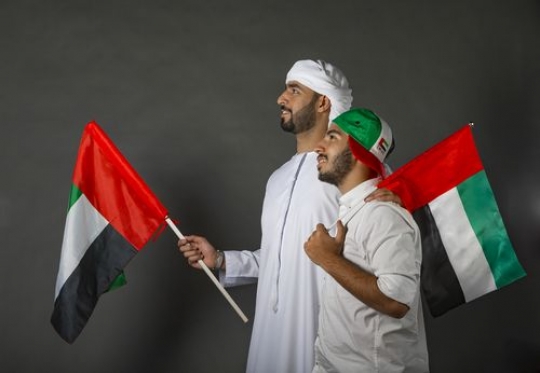 Two men proudly celebrating the UAE National Day