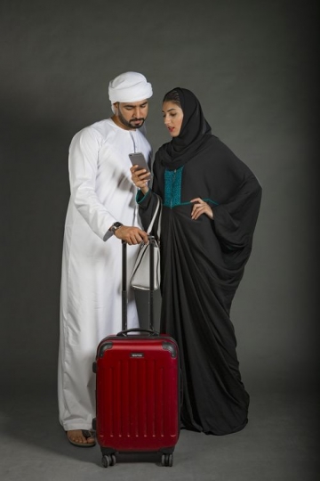 Middle Eastern woman showing the man something on her mobile|-