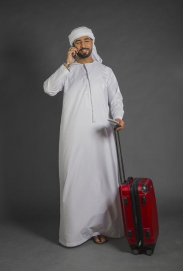 Arab Businessman talking on the phone explaining his car|-