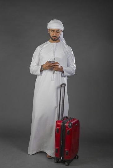 Middle Eastern Businessman texting on the phone|-