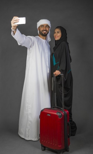 Arab man and woman taking a selfie together|