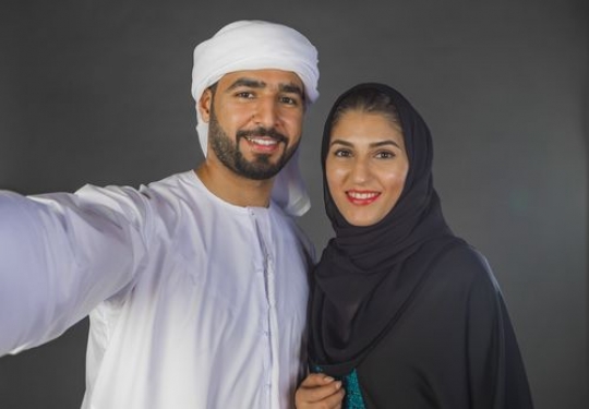 Middle Eastern couple taking a selfie together|-