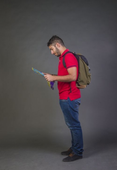 Young Arab man walking looking at the map|-