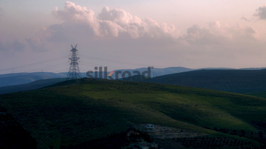 Sunset Landscape with Electric Tower and Rolling Hills