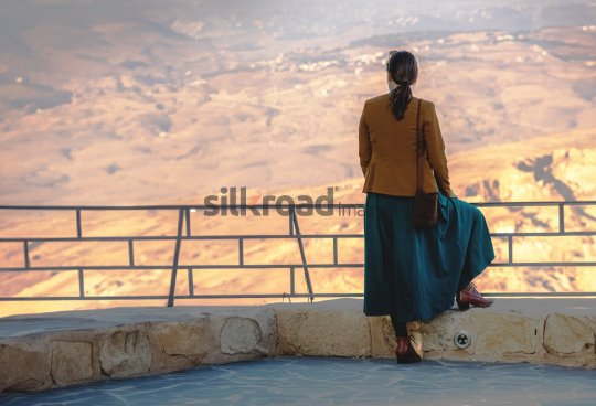 Tourist Enjoying the View from Mount Nebo, Jordan at Sunset