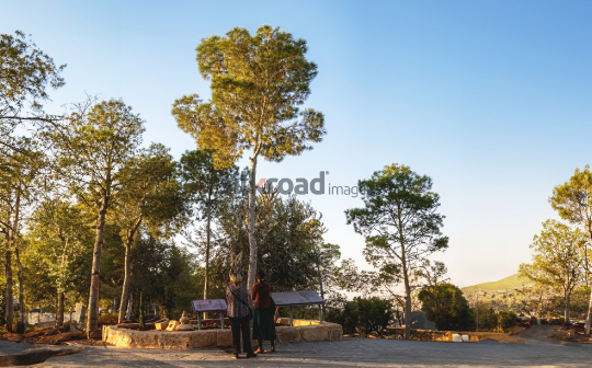 Visitors Exploring Mount Nebo, Jordan at Sunset