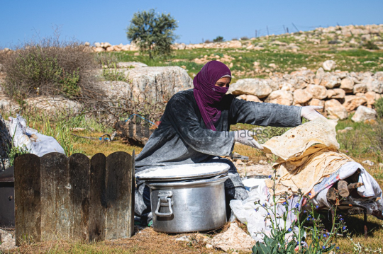 Woman Preparing Traditional Bread Outdoors in Garesa Village