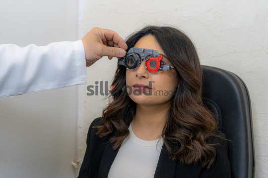 Woman Undergoing Eye Examination to Find the Right Lens with Doctor