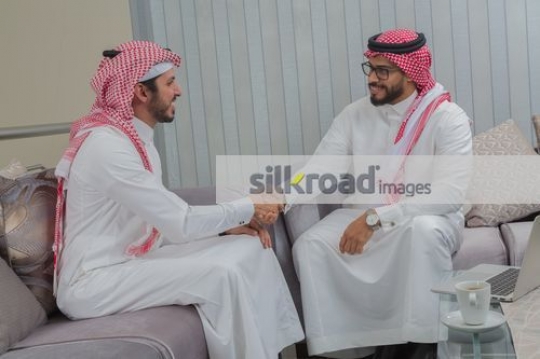 Businessmen sitting on the couch having a meeting|