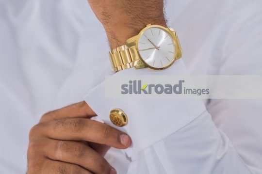 Middle Eastern Business man fixing the cufflink
