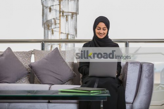 Business woman sitting on the couch working|