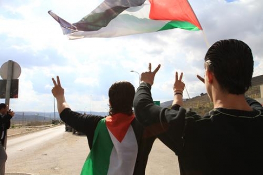 two young men showing peace si